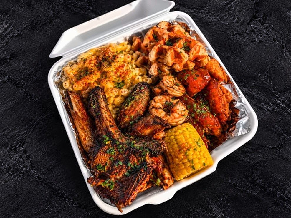 Lamb chops, wings, prawns, Blazing Shrimp, mac and cheese and corn on the cob in a takeaway box